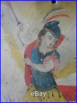 Saint Michael Defeating Lucifer' folk art icon, oil on metal, in curio cabinet