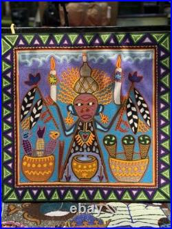 This is a traditional Huichol yarn painting from Mexico