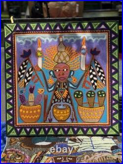 This is a traditional Huichol yarn painting from Mexico