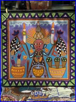 This is a traditional Huichol yarn painting from Mexico